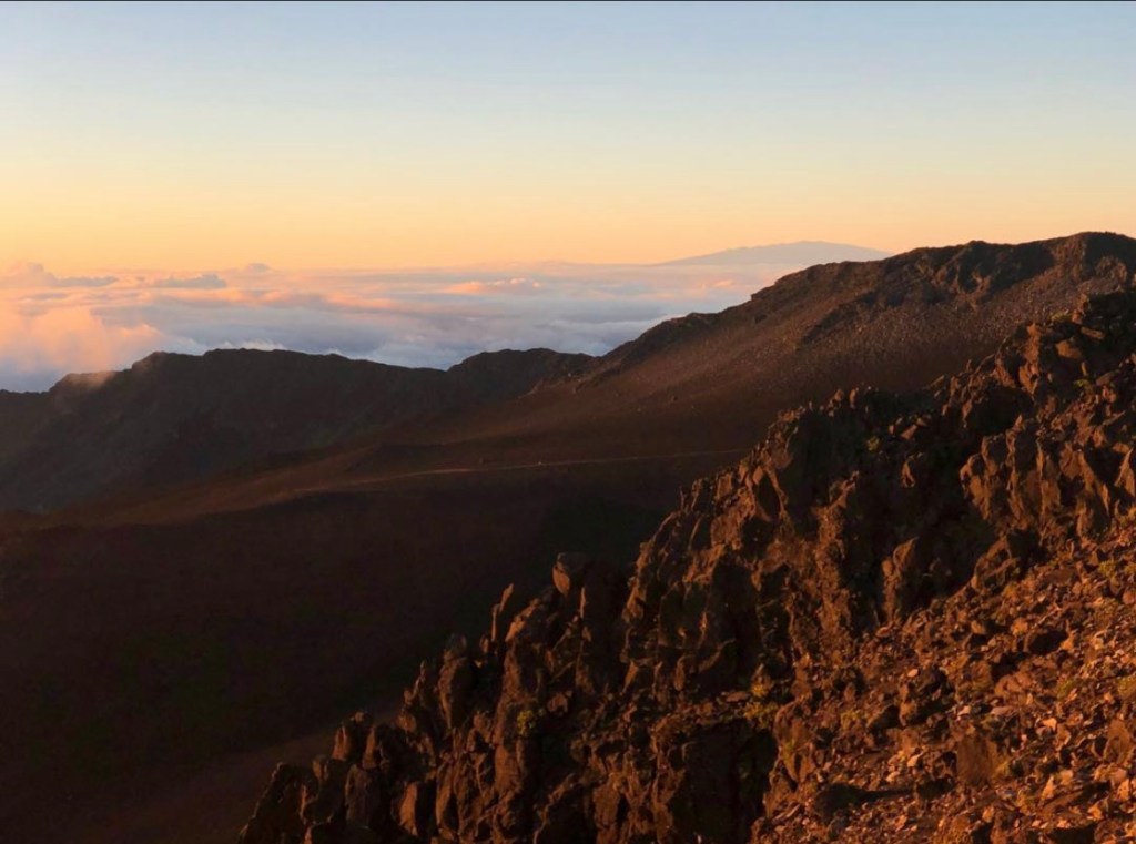 Volcanic rock glowing against sunrise in Haleakalā National Park.