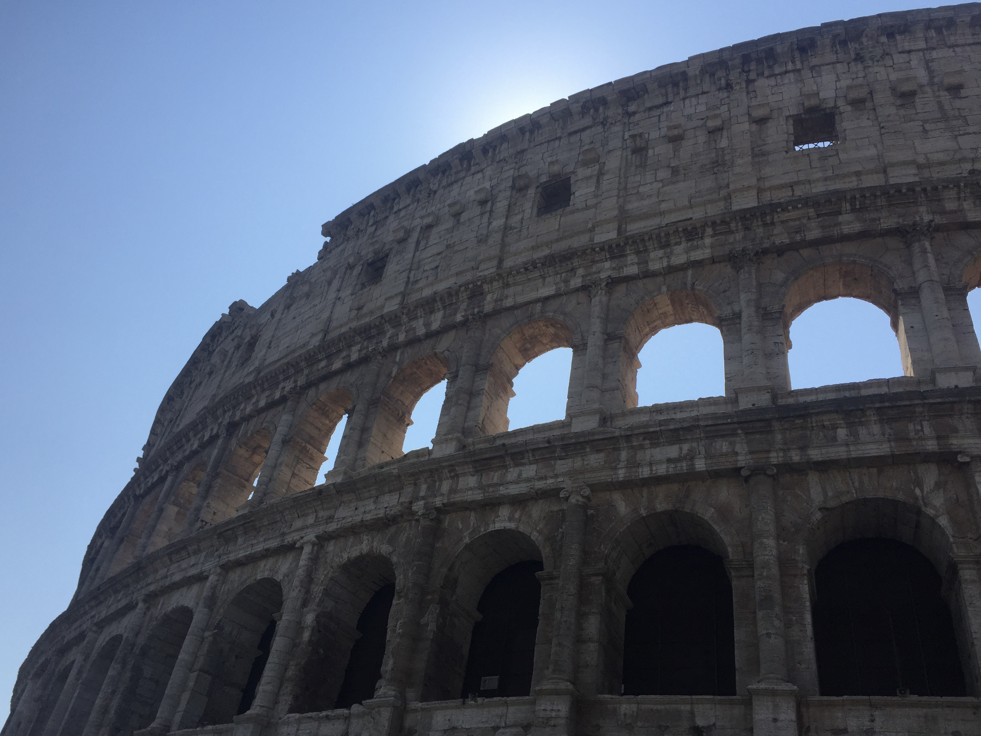 Roman architecture repetitive arches made of stone to make up the Roman Colosseum.