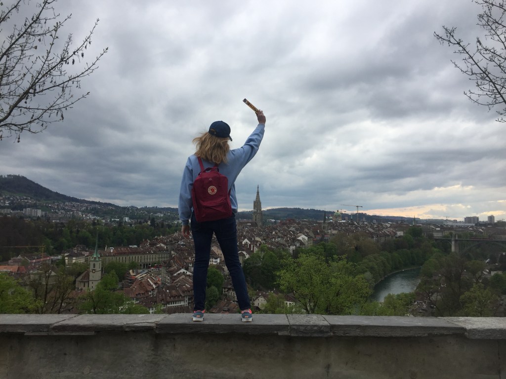 Girl standing above Bern, Switzerland overlook with Toblerone chocolate